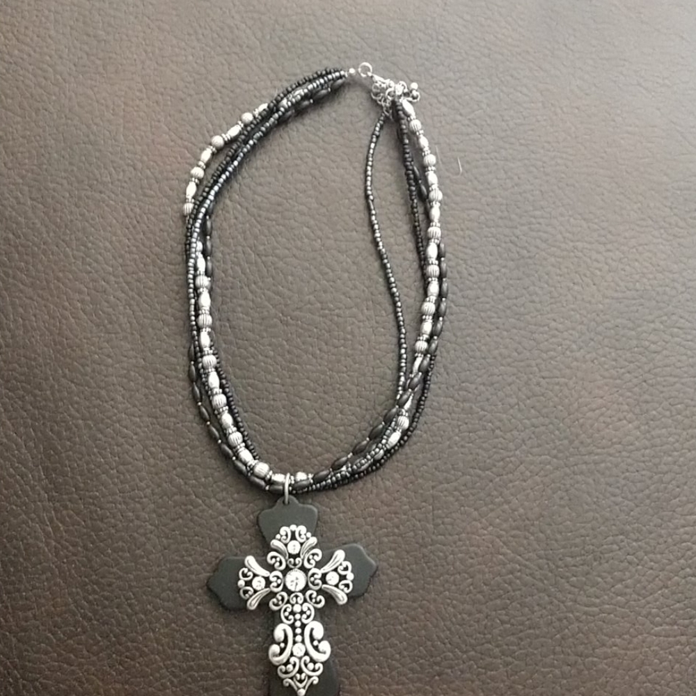 Women's black cross necklace.